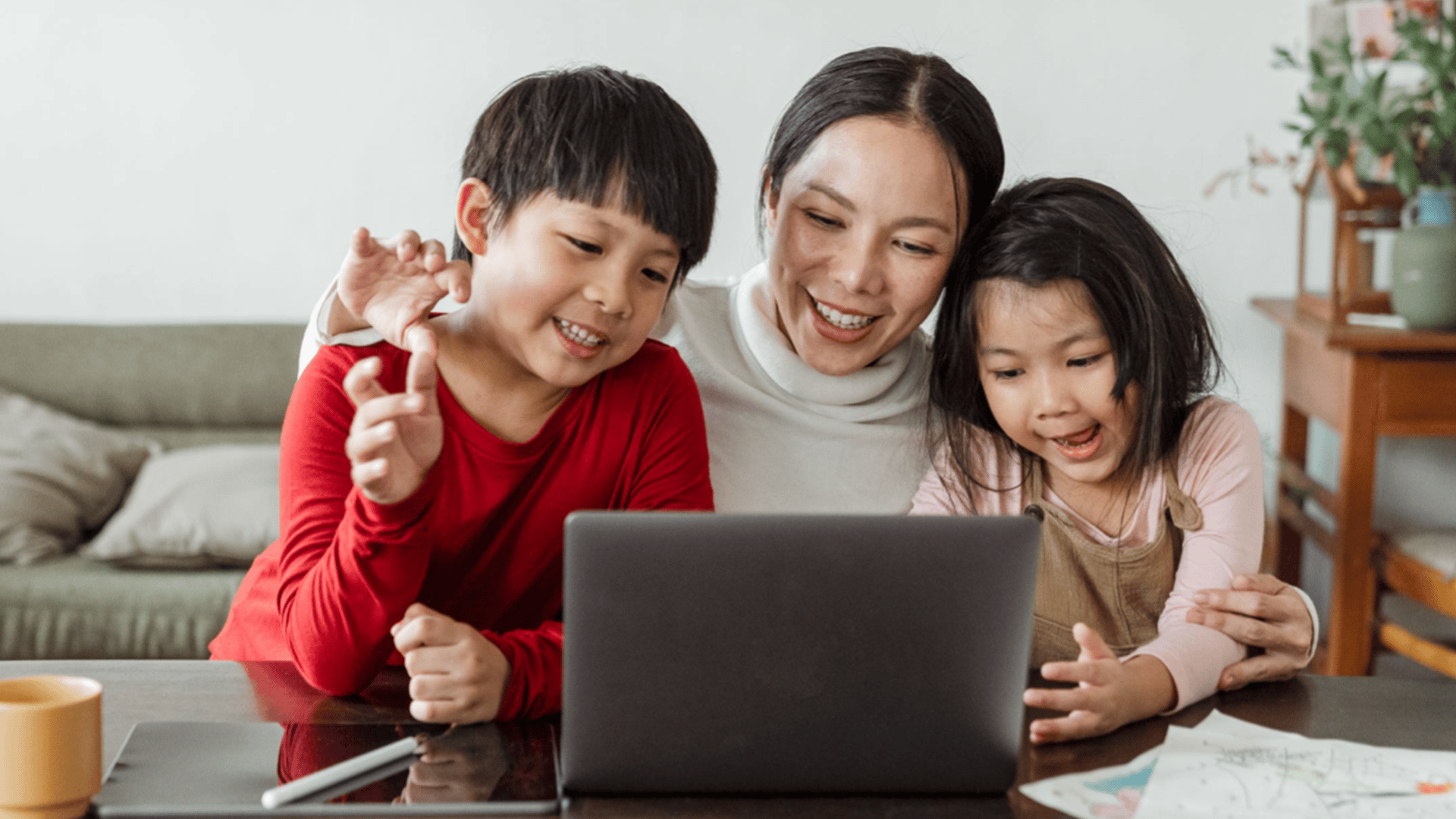 Family of three looking at laptop