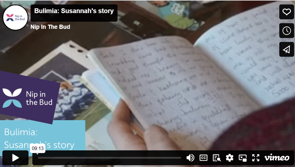 Photo shows the start of a video with a child opening an exercise book with writing in
